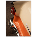 Close-up of a vintage car's rear end with a red light and chrome details.