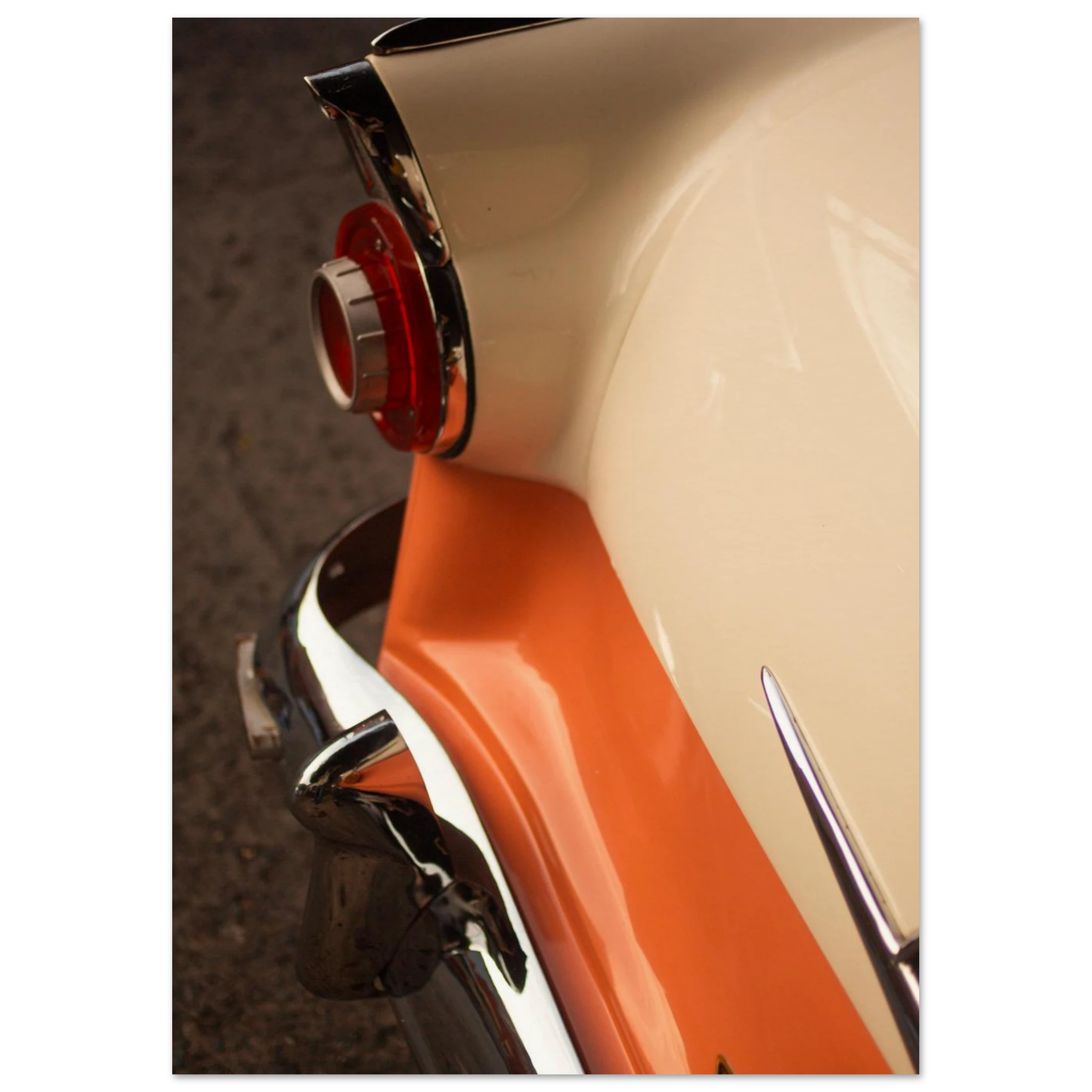 Close-up of a vintage car's rear end with a red light and chrome details.