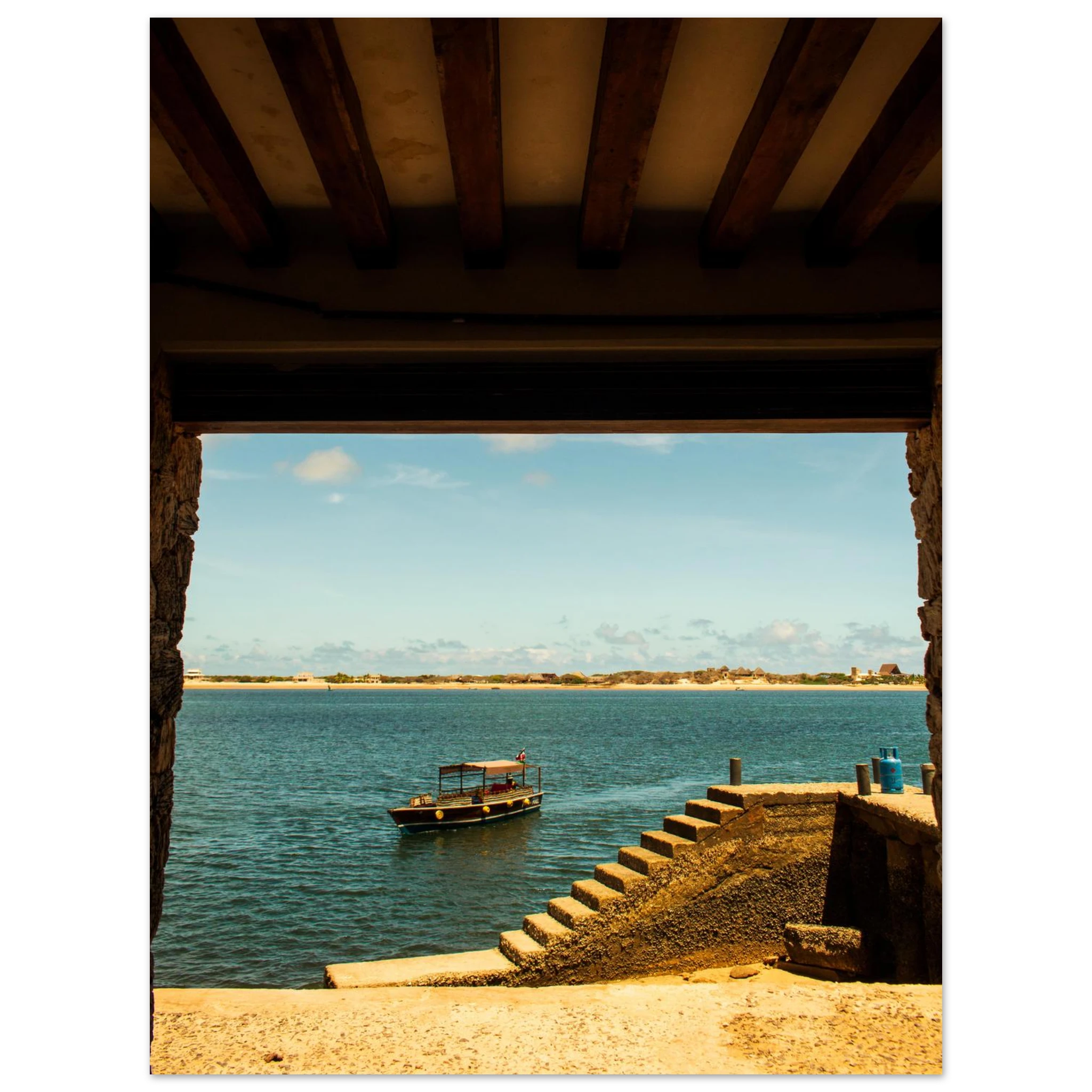 View of a dock with a boat on a body of water, framed by wooden beams.