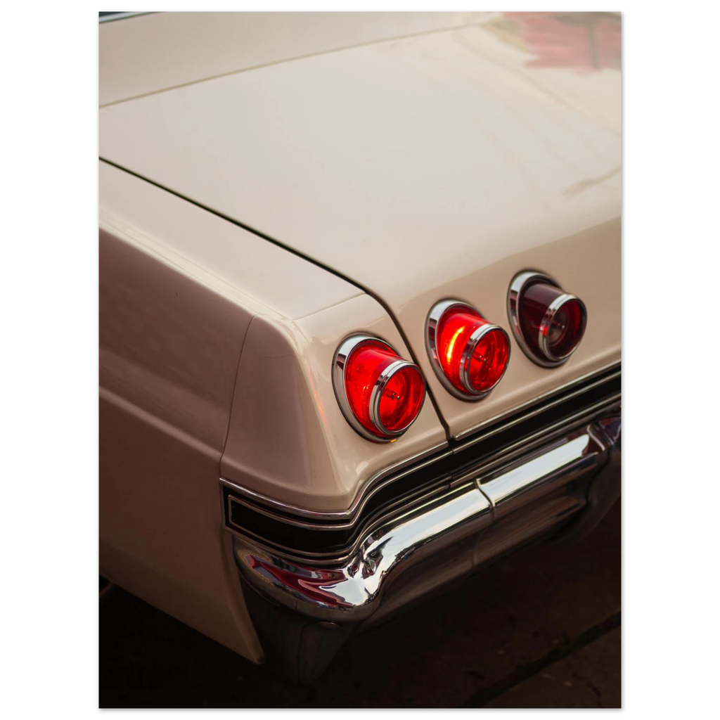 Close-up of a vintage car chevy impala rear lights with a beige body.