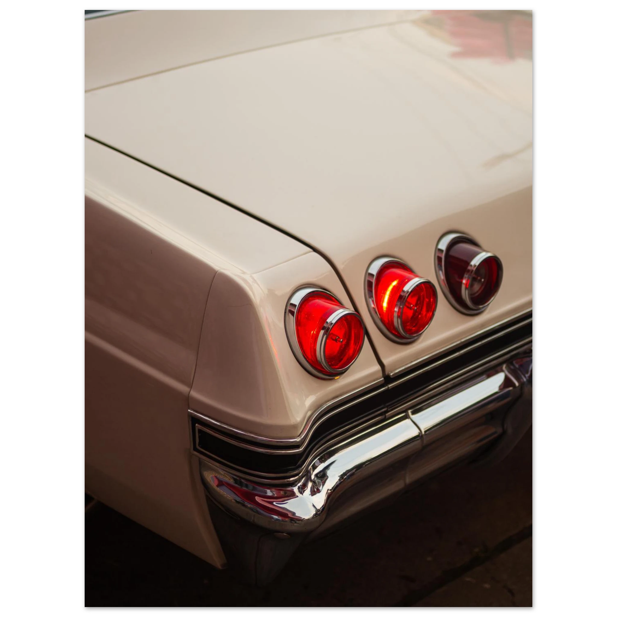 Close-up of a vintage car chevy impala rear lights with a beige body.