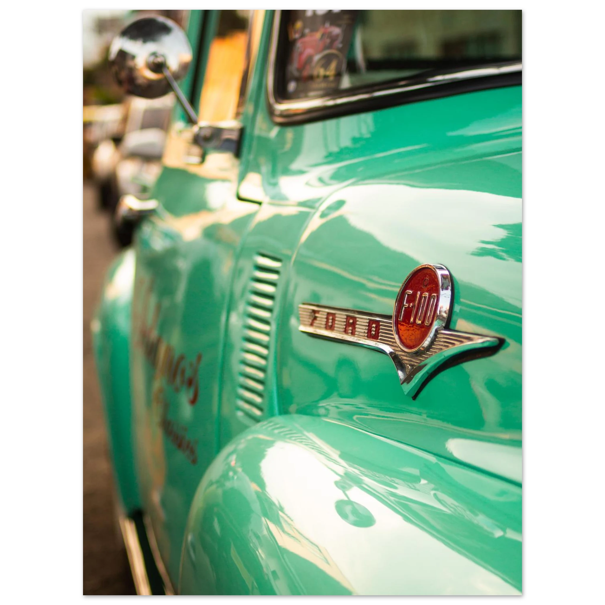 Close-up of a vintage green Ford truck with the logo visible.