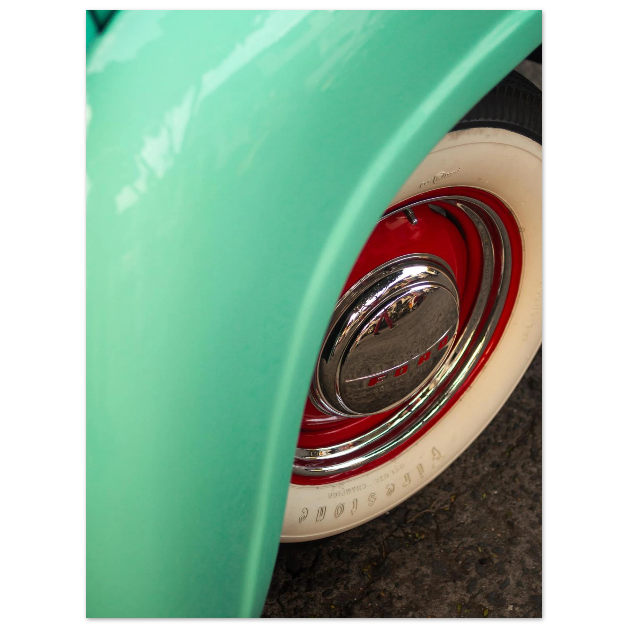 Close-up of a green vehicle's wheel with a red rim and white wall tire.